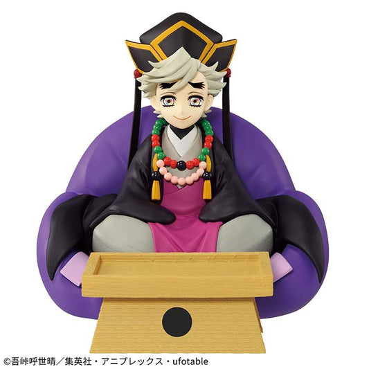 A direct frontal view of the 14cm Doma FigLife! figure. The character is posed symmetrically behind a small yellow accessory tray intended for keys or coins. The figure features detailed paintwork on his beaded necklaces, traditional black hat, and red-and-black robes.