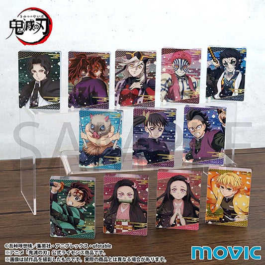 The complete set of 12 Demon Slayer Noble Art Collection A acrylic blocks displayed on tiered transparent stands. The collection features various  characters, including Tanjiro Kamado, Nezuko Kamado, and Muzan, each styled with vibrant colors and traditional Japanese pattern borders.