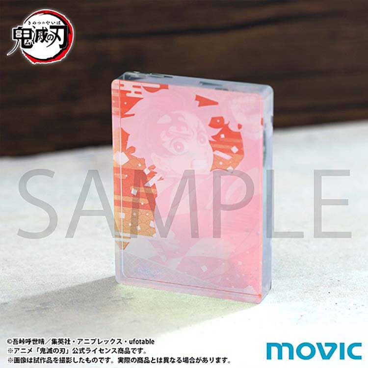 A close-up, angled view of a Demon Slayer Noble Art acrylic block featuring Tanjiro Kamado. The image highlights the thickness and transparency of the premium acrylic material, which creates a multi-layered, three-dimensional effect for the character artwork.