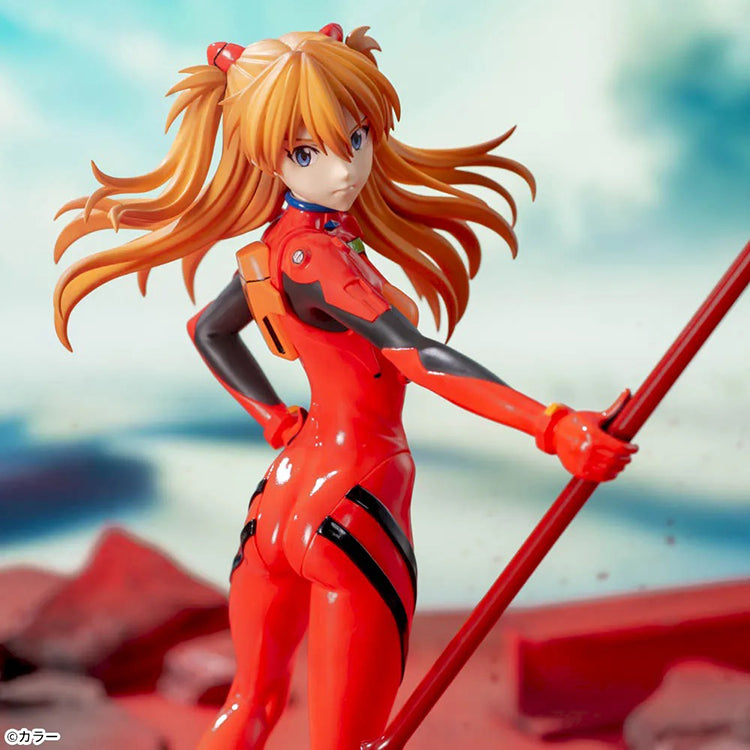 Shin Evangelion Theatrical Version Luminasta figure of Asuka Langley Shikinami wearing a glossy red plugsuit, standing in a dynamic pose while holding the large Spear of Cassius. The figure is displayed on a red base with a marble-like background.