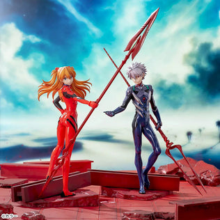 Shin Evangelion Theatrical Version Luminasta figure of Asuka Langley Shikinami wearing a glossy red plugsuit, standing in a dynamic pose while holding the large Spear of Cassius. The figure is displayed on a red base with a marble-like background.