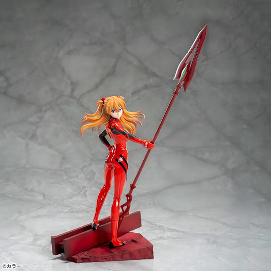 Shin Evangelion Theatrical Version Luminasta figure of Asuka Langley Shikinami wearing a glossy red plugsuit, standing in a dynamic pose while holding the large Spear of Cassius. The figure is displayed on a red base with a marble-like background.