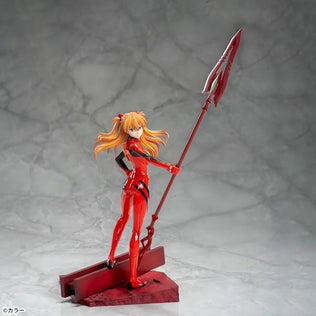 Shin Evangelion Theatrical Version Luminasta figure of Asuka Langley Shikinami wearing a glossy red plugsuit, standing in a dynamic pose while holding the large Spear of Cassius. The figure is displayed on a red base with a marble-like background.
