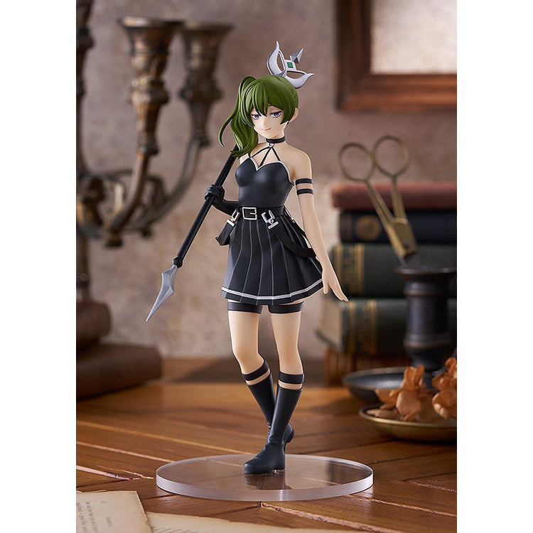 Übel POP UP PARADE figure from Frieren, full front view on clear round base, posed on a desk with old books and scissors