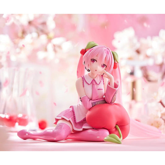 Hatsune Miku Sakura Miku Cherry Cushion Ver. figure by Taito sitting against a cherry cushion with pink Sakura-inspired colors.