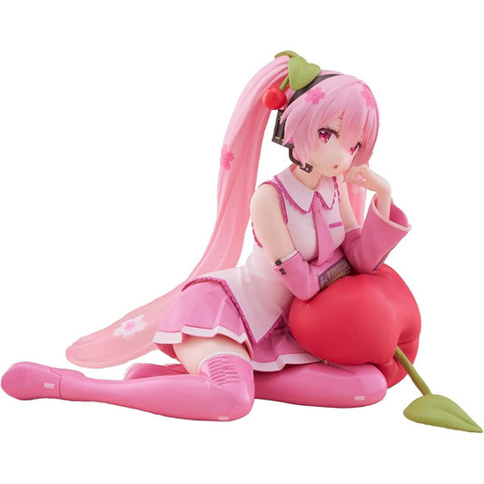 Hatsune Miku Sakura Miku Cherry Cushion Ver. figure by Taito sitting against a cherry cushion with pink Sakura-inspired colors.