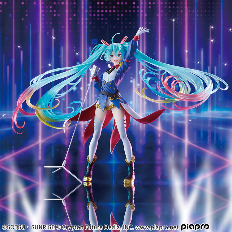 A high-quality frontal shot of the Gundam x Hatsune Miku figure against a solid blue background, emphasizing the translucent clear parts and 4-color gradient of her hair.
