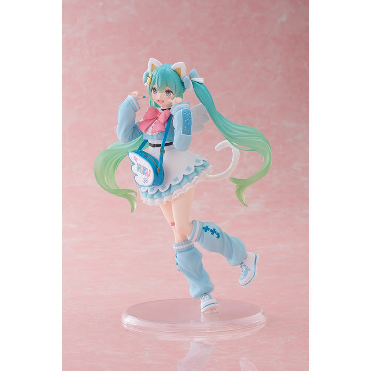 Side-angle full-body view of the Taito Vocaloid figure, showcasing the layered ruffles of her blue skirt and oversized slouchy leg warmers.