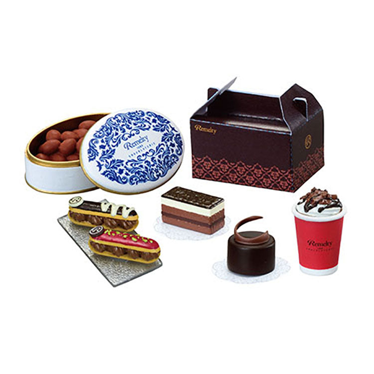 Miniature chocolate shop set from the Re-Ment Petit Chocolaterie series, featuring tiny chocolates, desserts, and a display showcase.