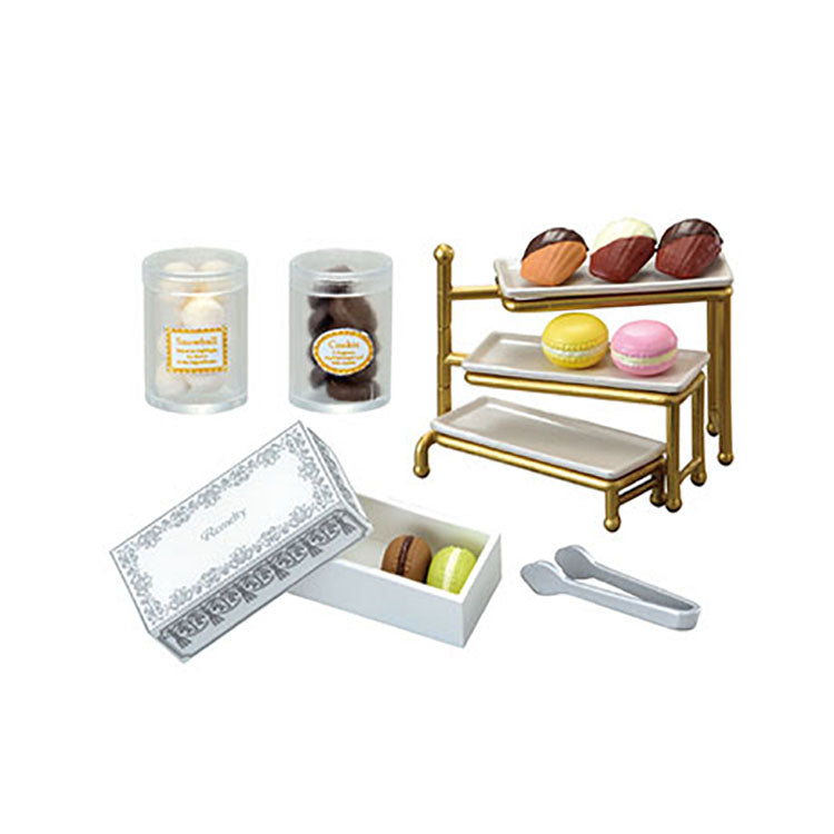 Miniature chocolate shop set from the Re-Ment Petit Chocolaterie series, featuring tiny chocolates, desserts, and a display showcase.