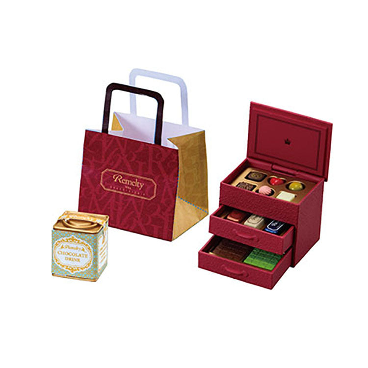 Miniature chocolate shop set from the Re-Ment Petit Chocolaterie series, featuring tiny chocolates, desserts, and a display showcase.