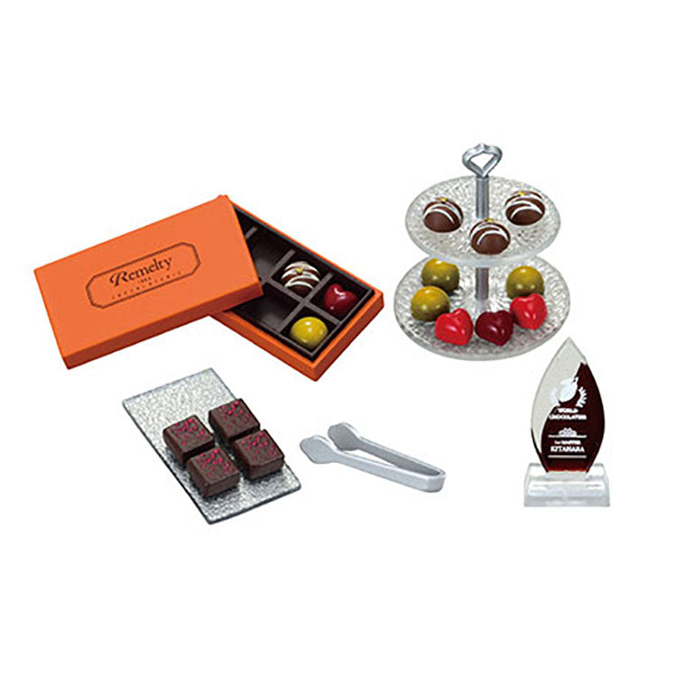 Miniature chocolate shop set from the Re-Ment Petit Chocolaterie series, featuring tiny chocolates, desserts, and a display showcase.