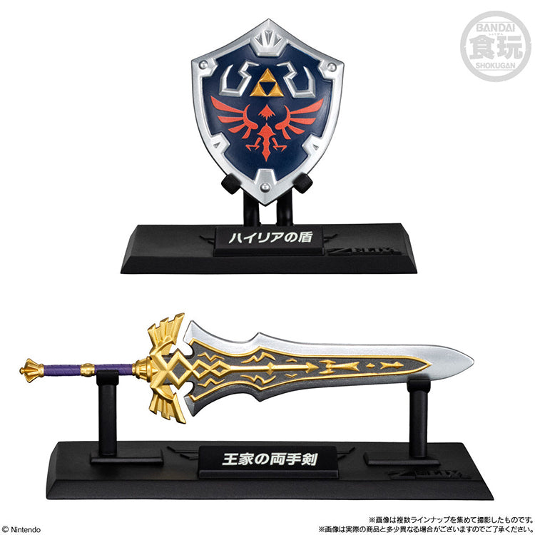 The Legend of Zelda miniature Hylian Shield and Royal Claymore weapon collection figures with display pedestals.